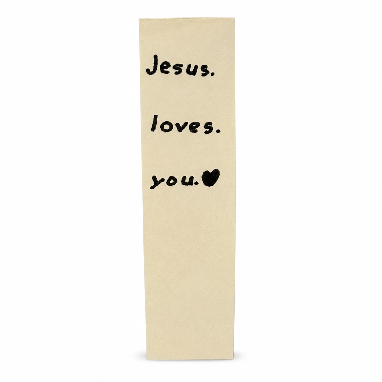 A cream card in black marker reading, on three short lines, Jesus. loves. you. with a small filled-in heart after the last word.